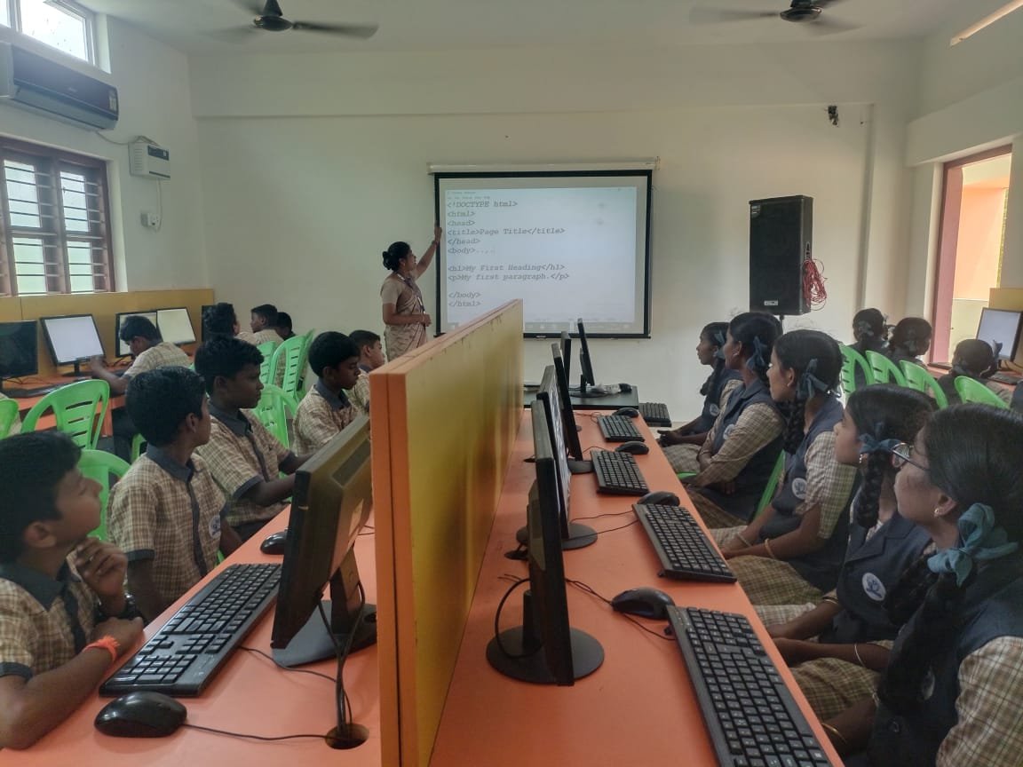Computer teacher guiding student